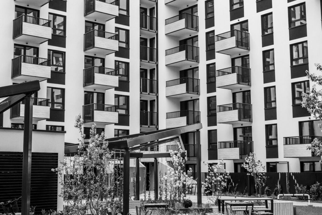 pexels-photo-31640055-31640055 Contemporary urban apartment building with balconies and courtyard, black and white.