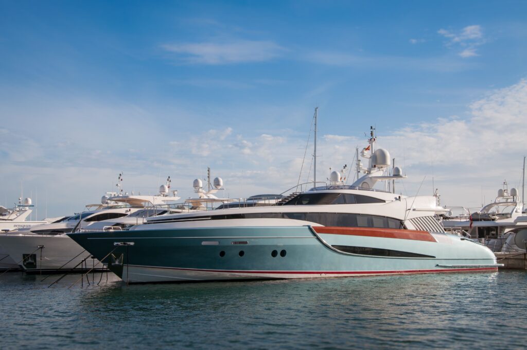 pexels-photo-42091-42091 A collection of sleek yachts docked at a serene marina with a bright blue sky above.